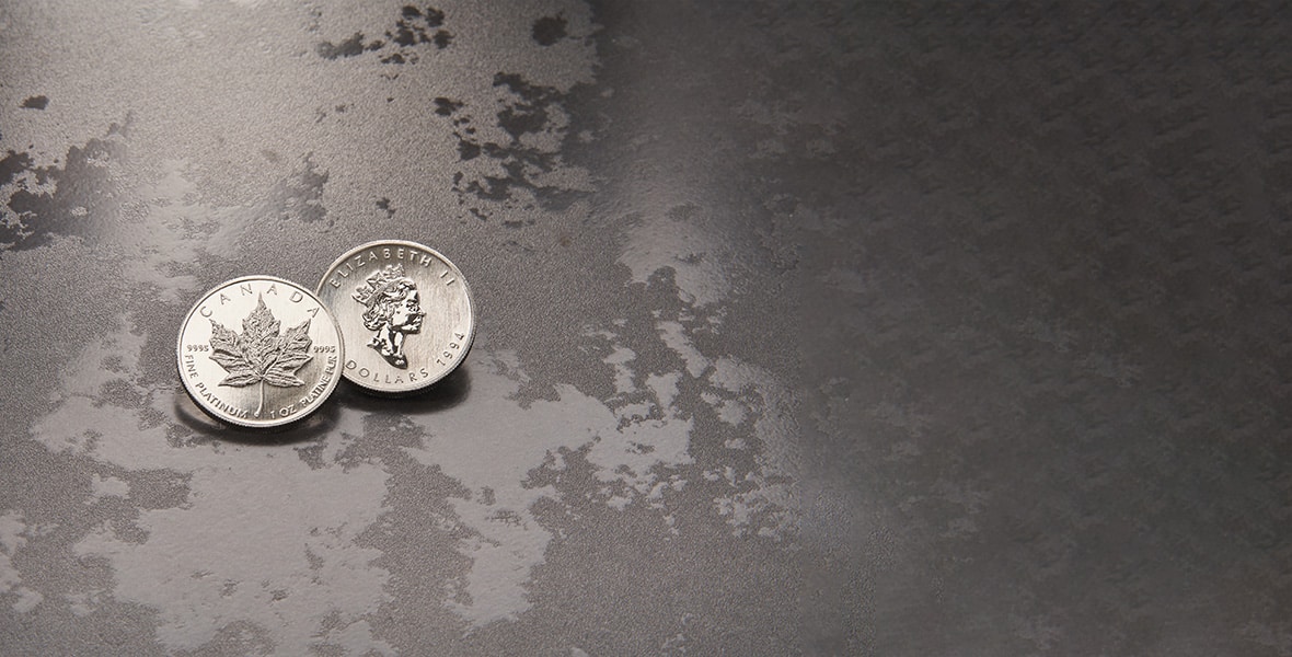 platinum canadian maple leaf coins on grey background